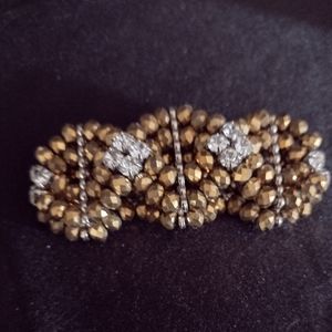 Gold/bronze beaded stretch bracelet with white stones